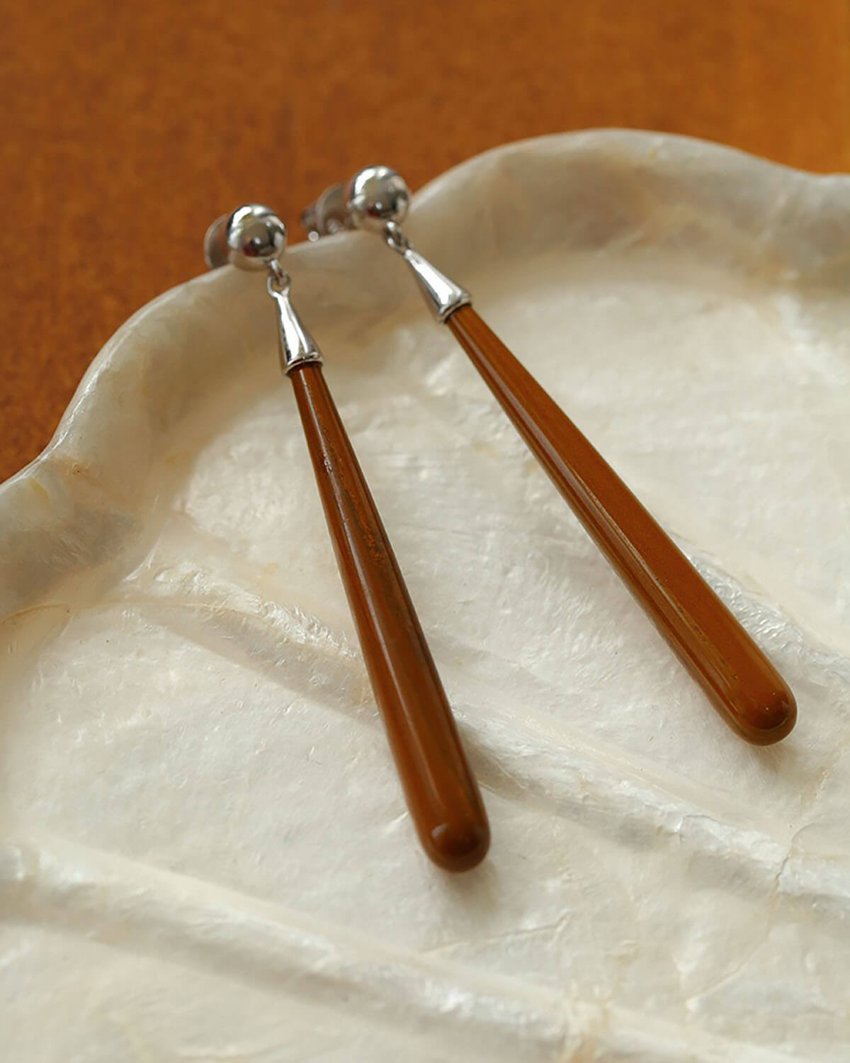 two wooden spoons sitting on top of a white plate