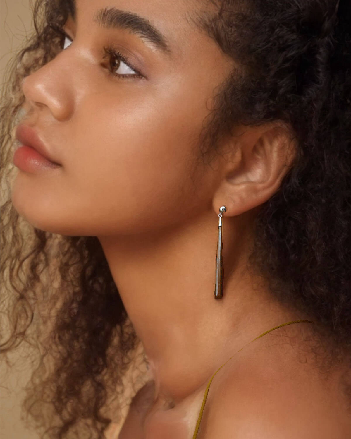 a close up of a person wearing a pair of earrings