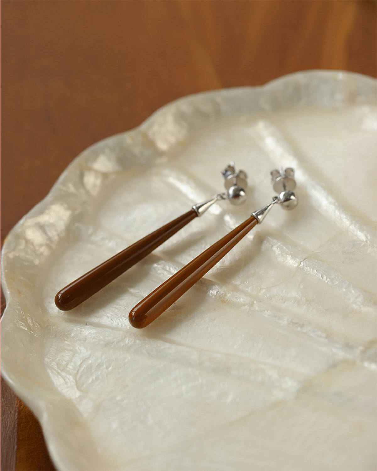 a couple of wooden spoons sitting on top of a white plate