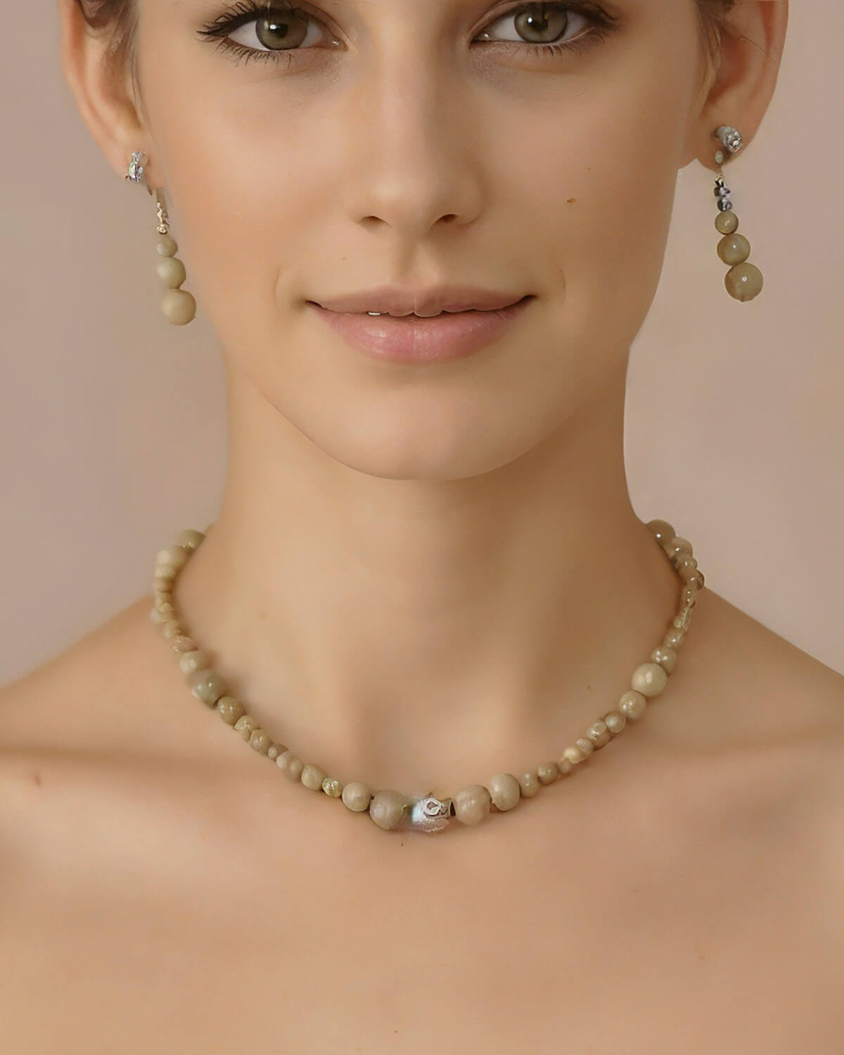 a woman wearing a necklace and earrings