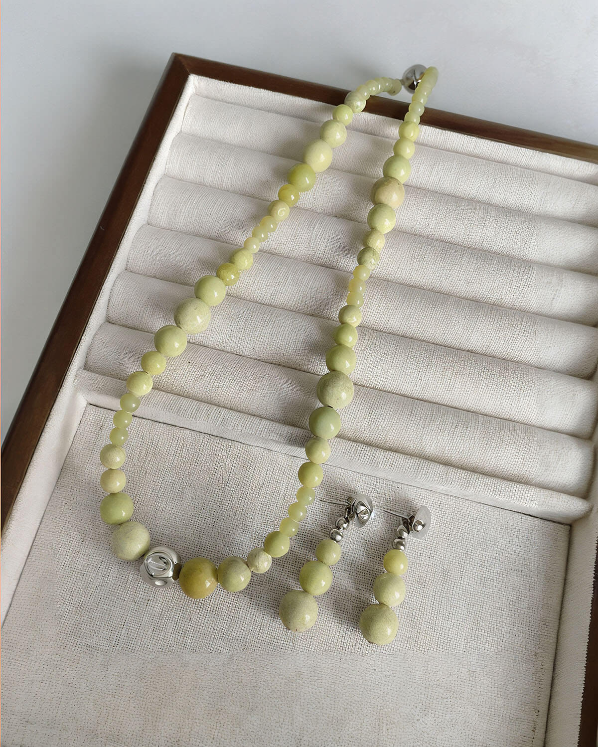 a necklace and earring set in a box