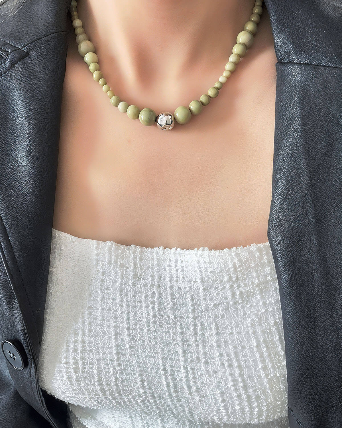 a close up of a person wearing a necklace