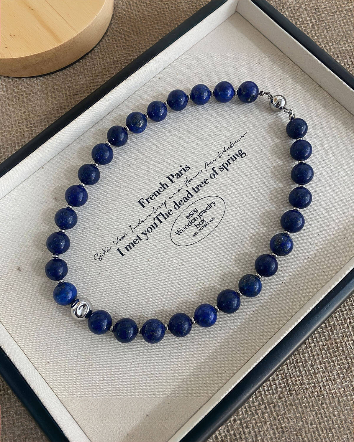 a blue beaded bracelet in a box