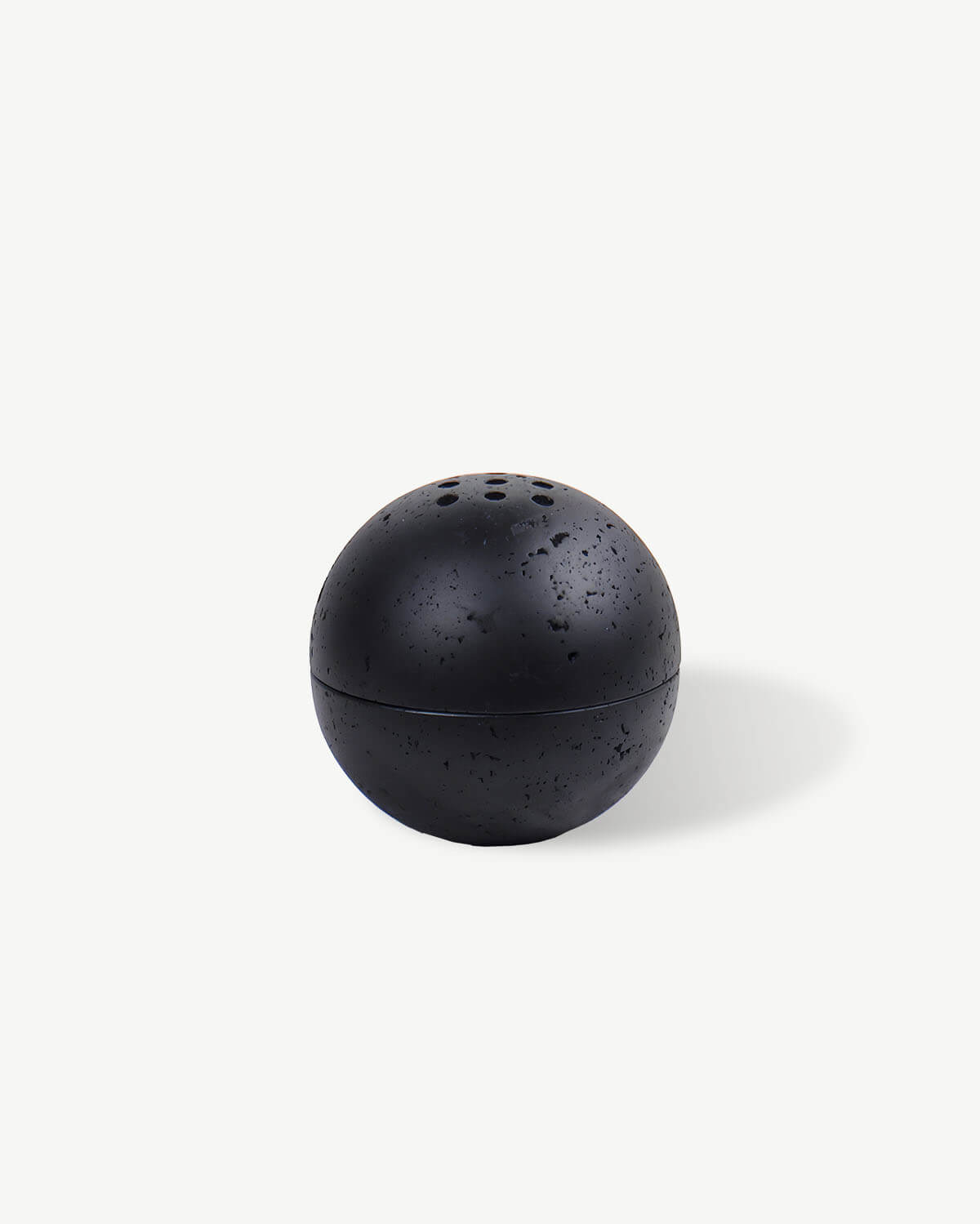 a small black object on a white surface