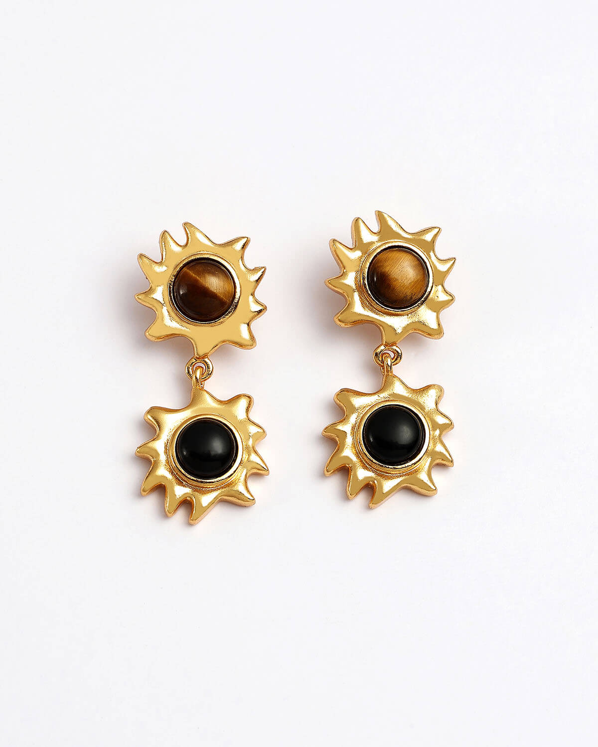 a pair of earrings with a tiger's eye