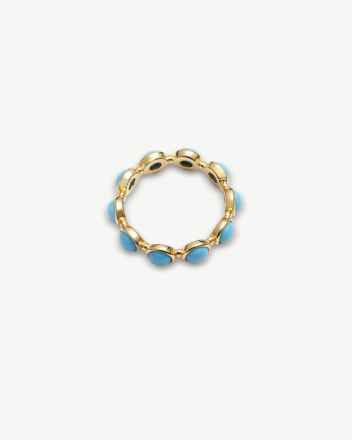 a gold ring with blue stones on a white background