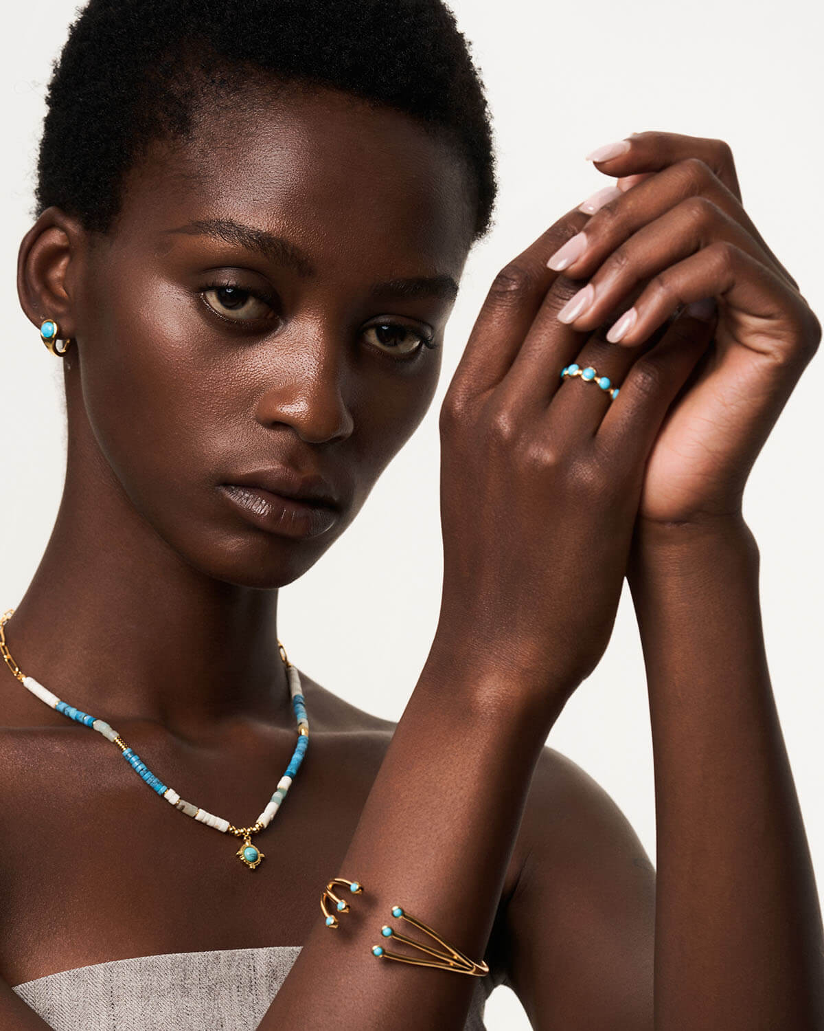 a woman wearing a necklace and bracelet with beads