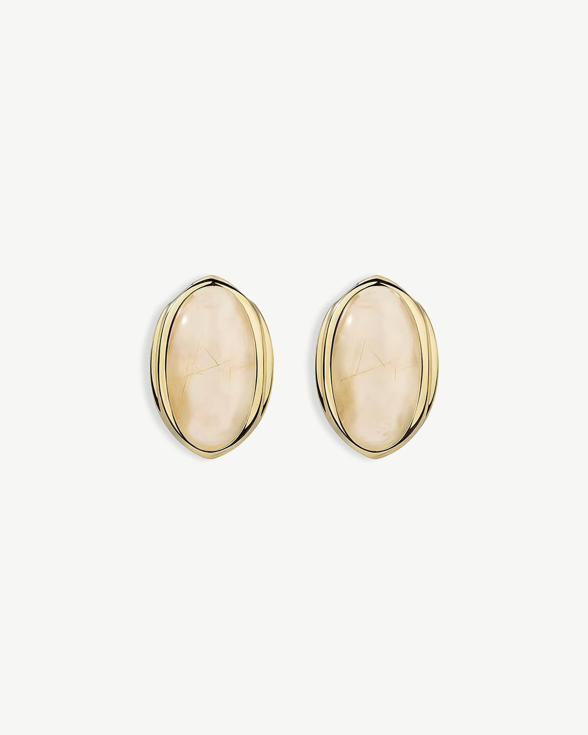 a pair of gold earrings with a white background