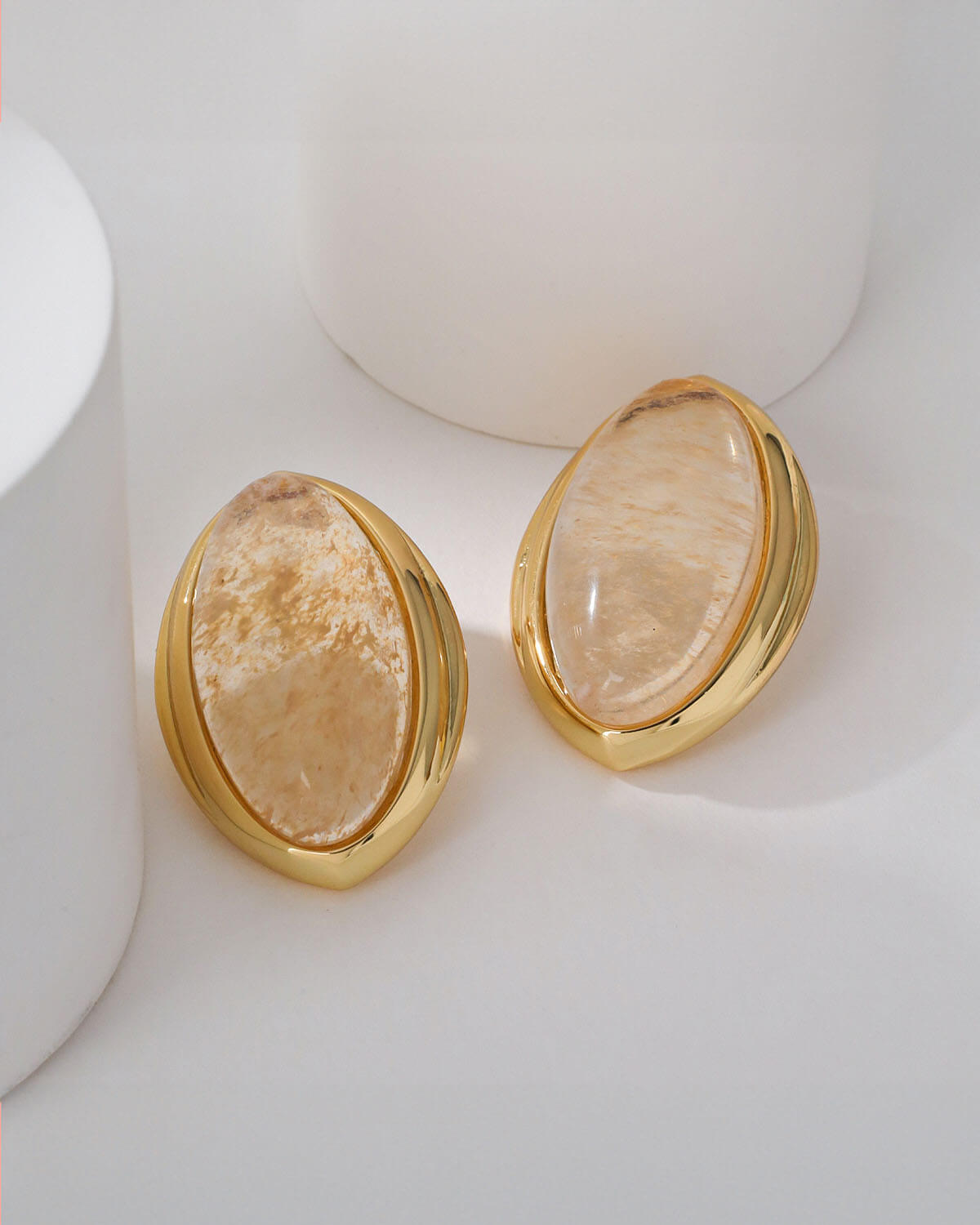 a pair of gold - plated and mother of pearl earrings