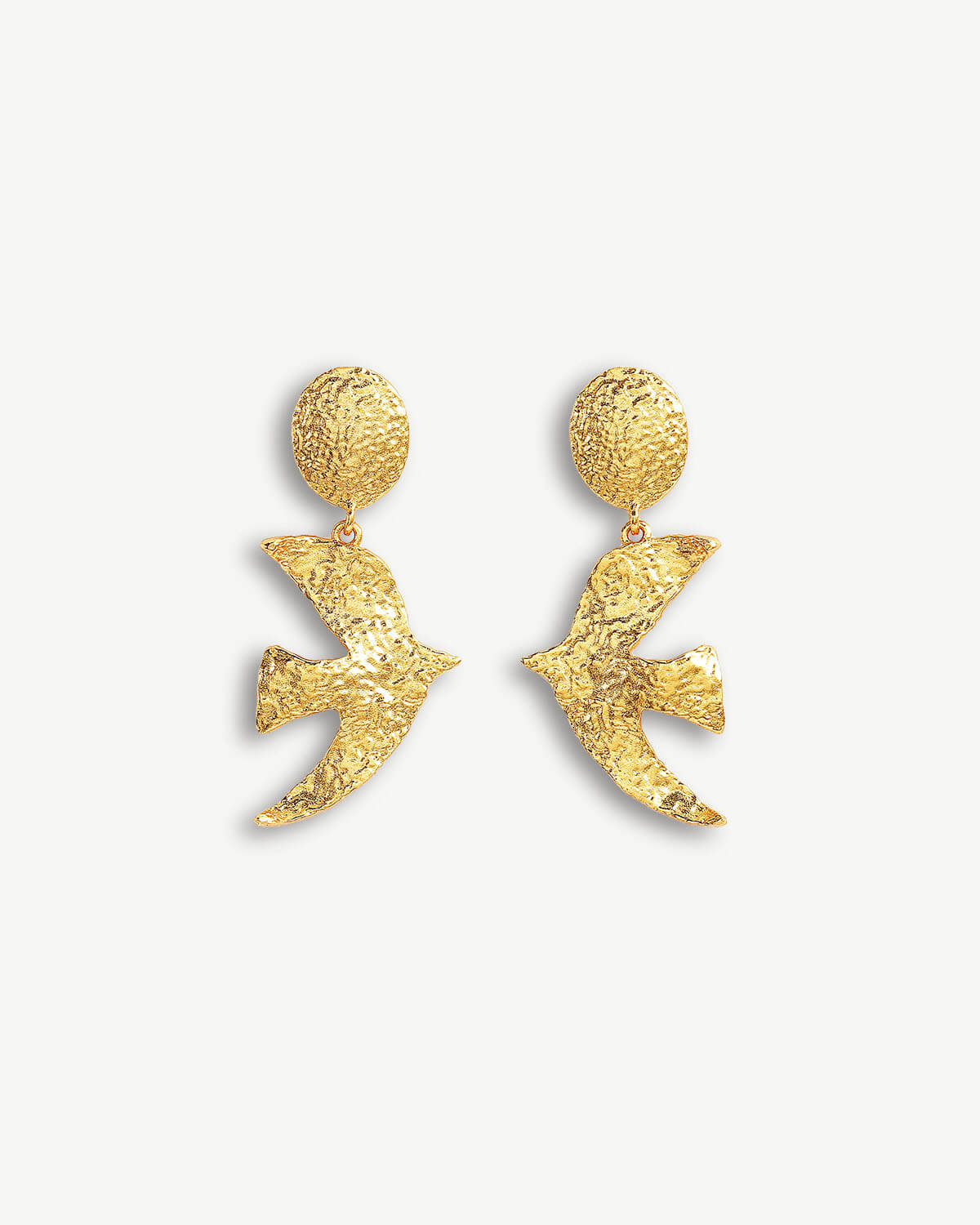 a pair of gold earrings on a white background