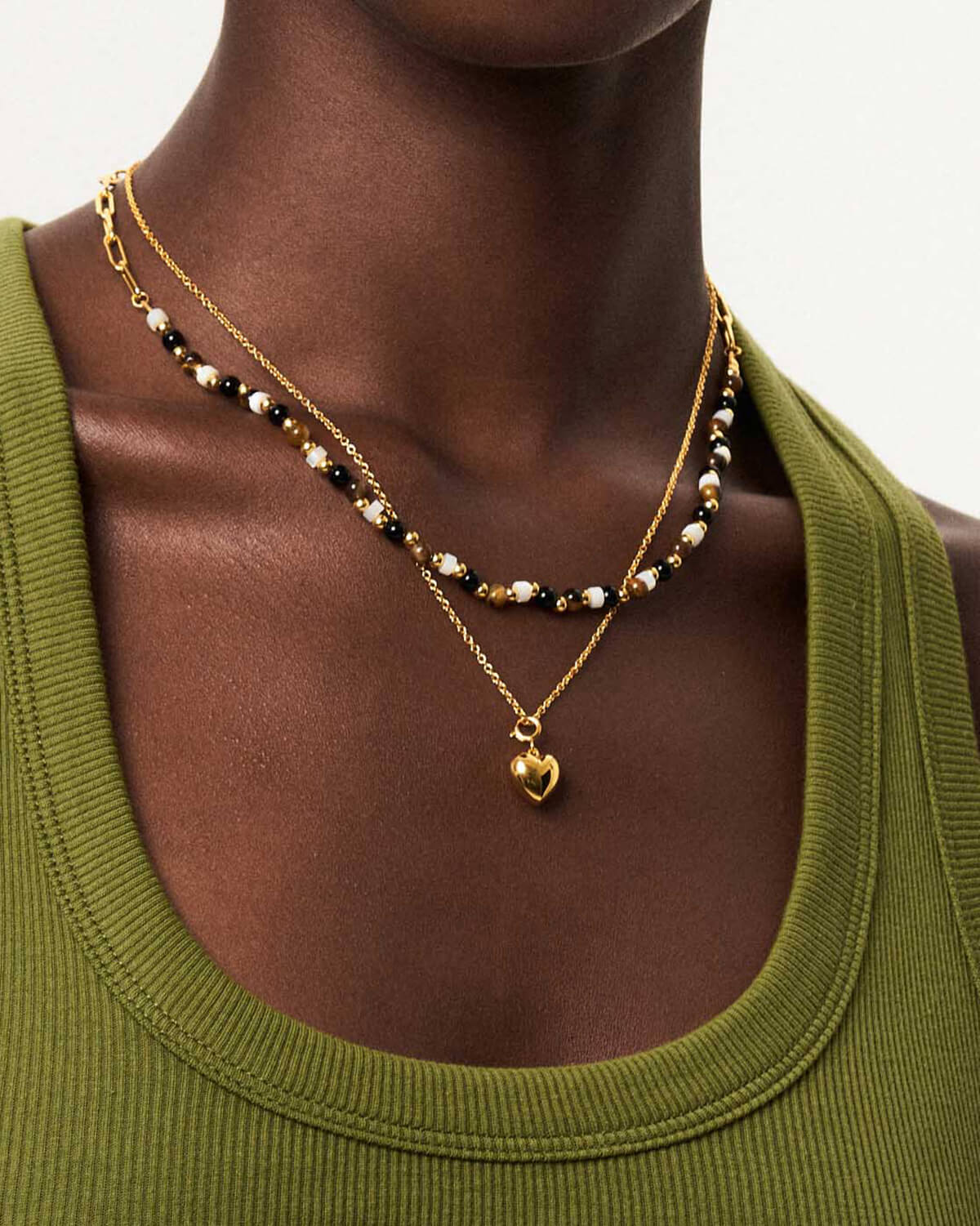 a close up of a woman wearing a necklace