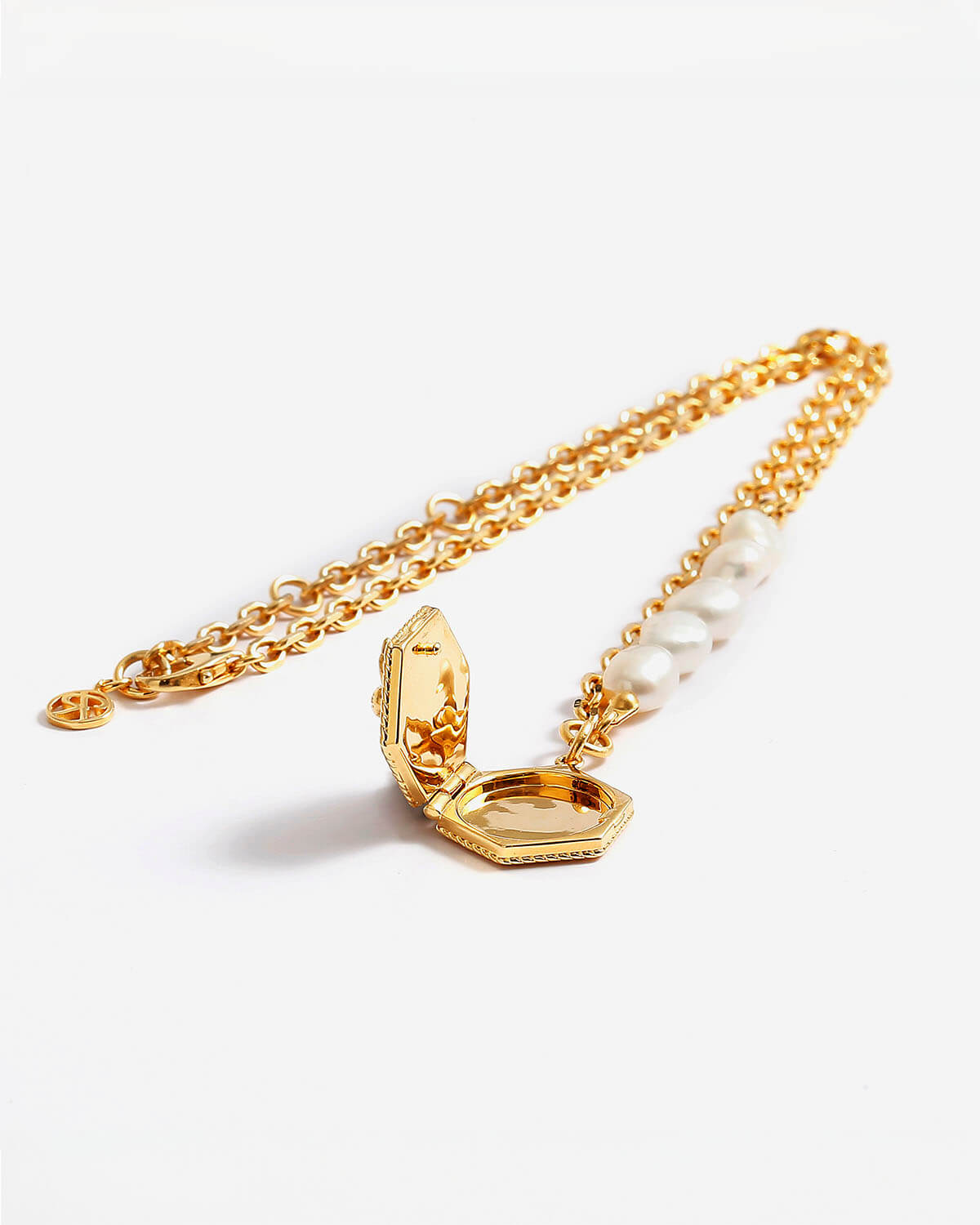 a gold chain with a ring and a pearl bead