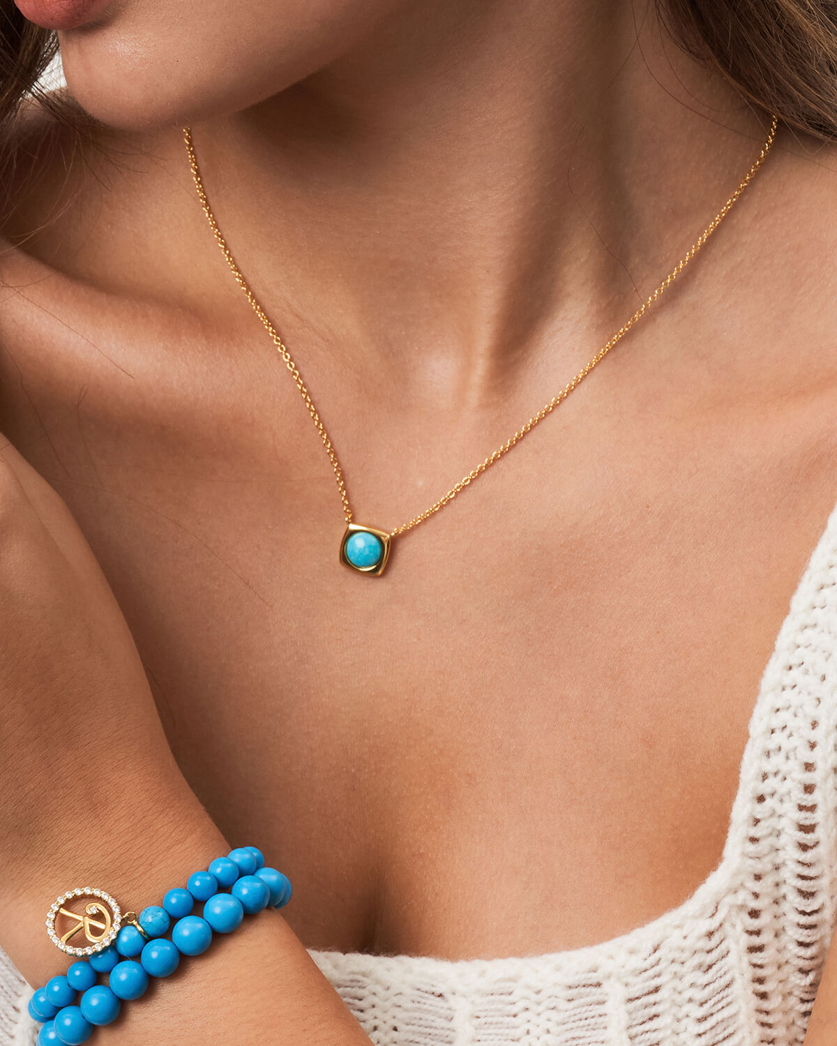 a woman wearing a bracelet with a peace sign on it