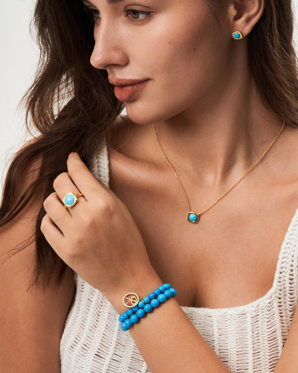 a woman wearing a blue beaded bracelet