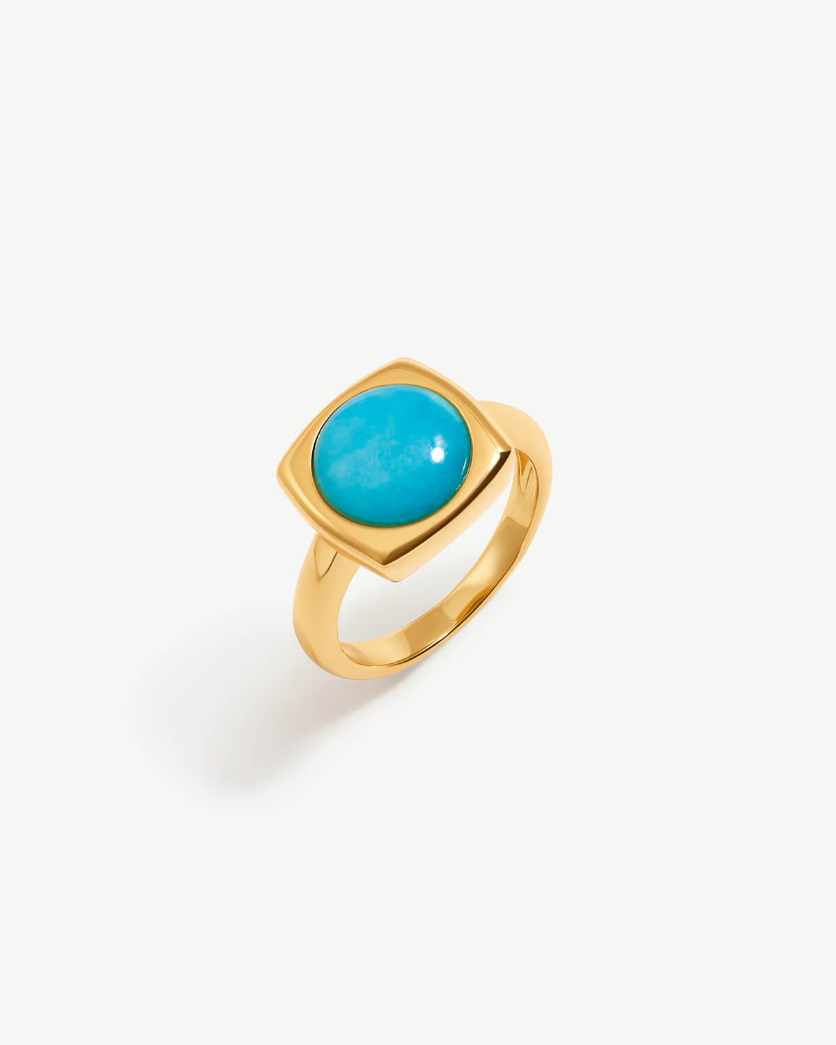 a gold ring with a turquoise stone