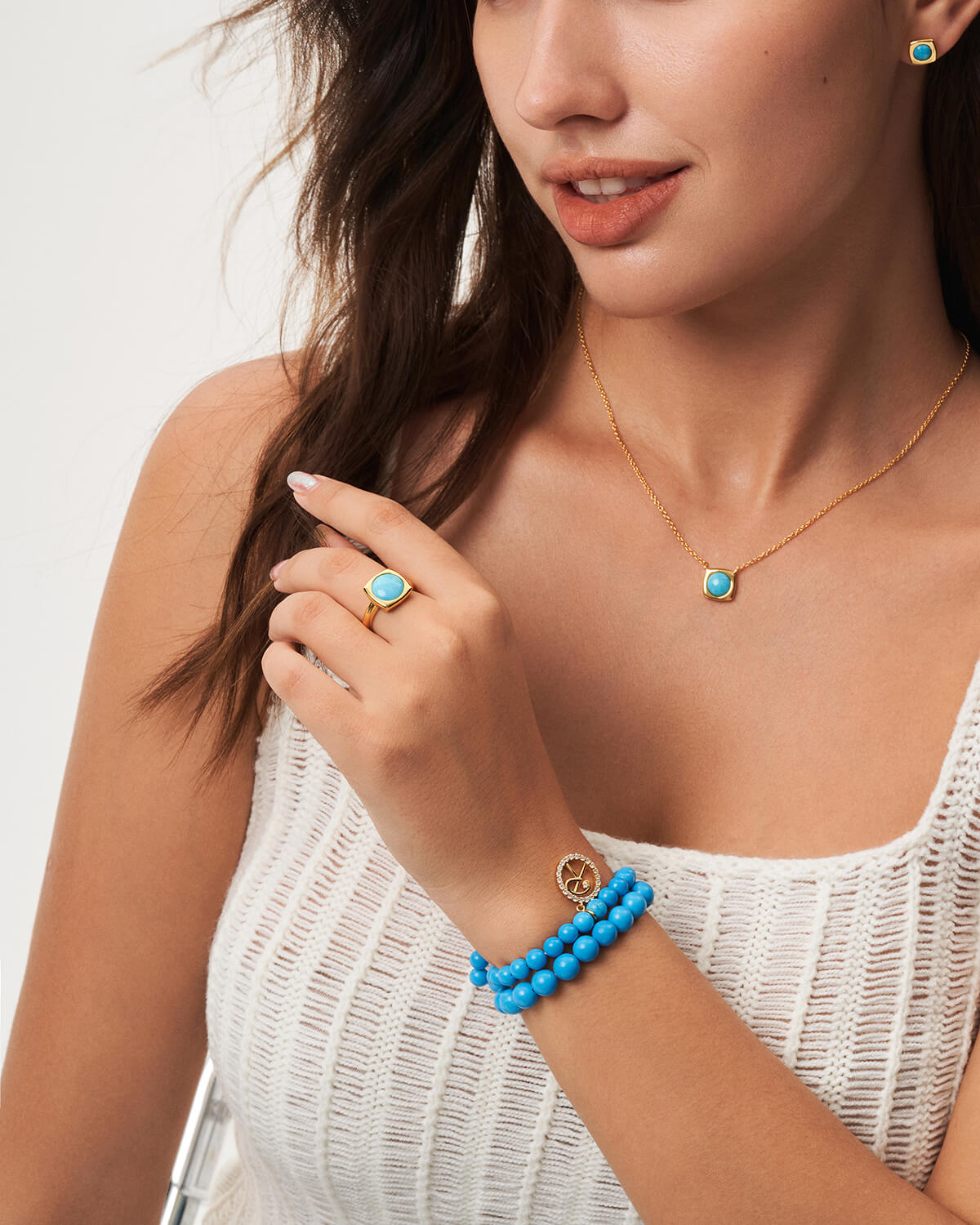 a woman wearing a blue beaded bracelet