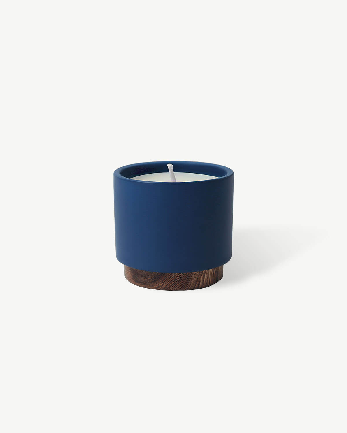 a blue candle sitting on top of a white table