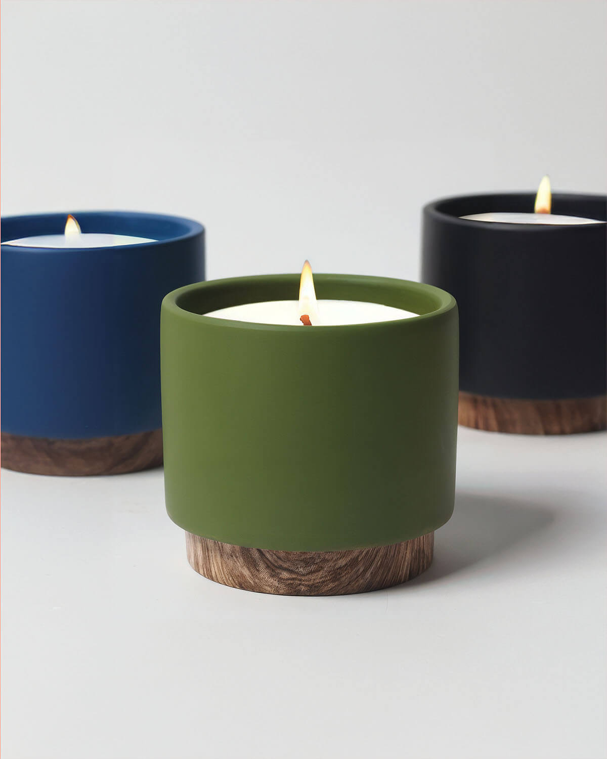 three different colored candles sitting next to each other