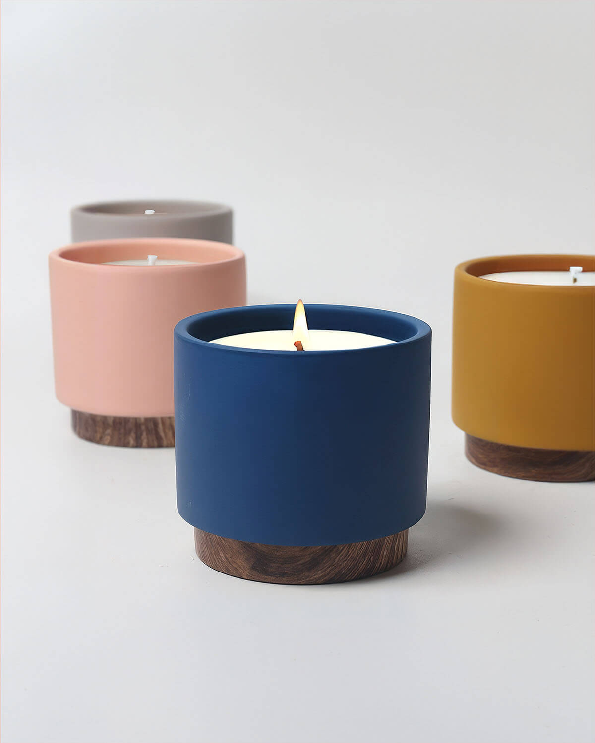 three different colored candles sitting next to each other