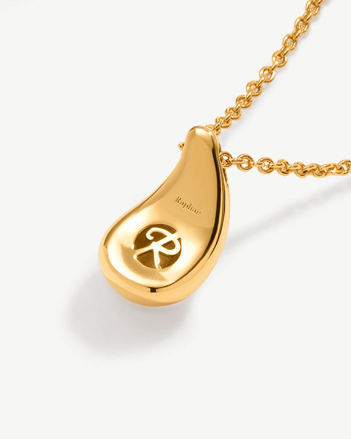 a gold necklace with a pendant on a chain