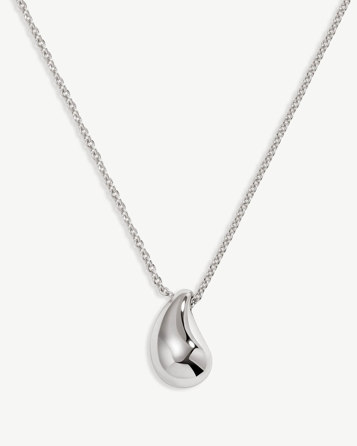 a silver necklace on a white background