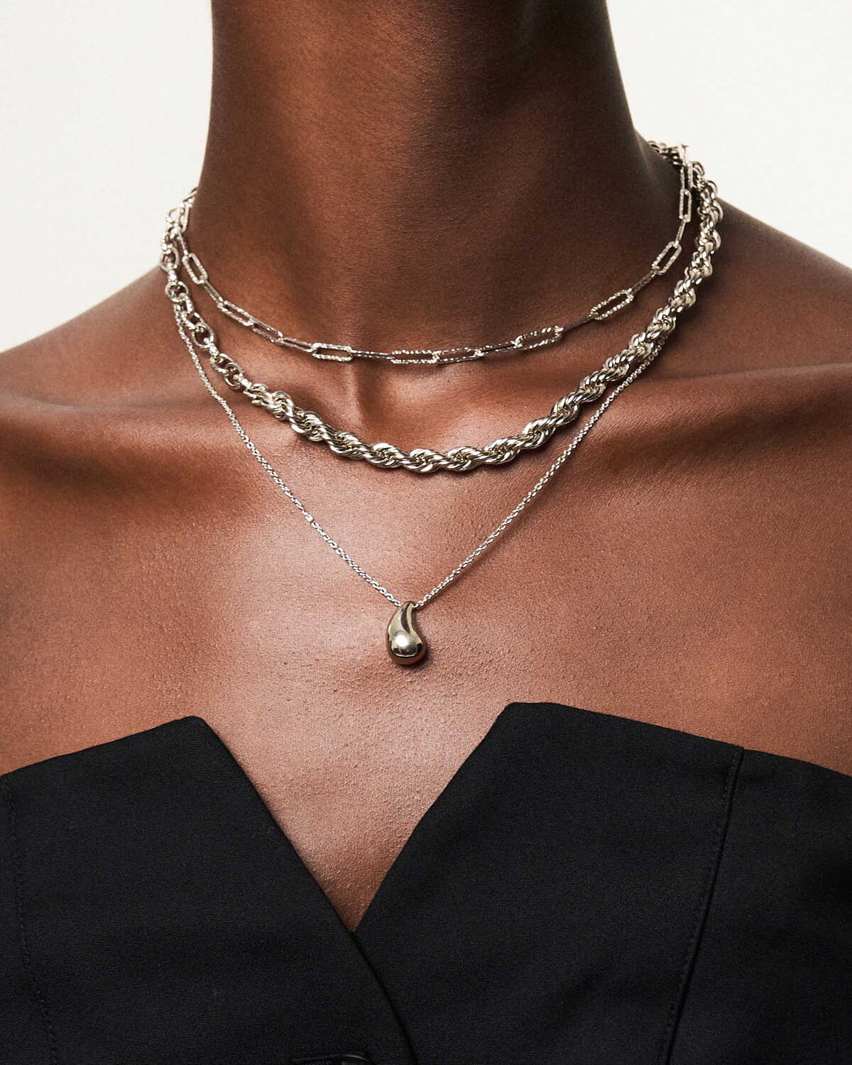 a close up of a woman wearing a necklace