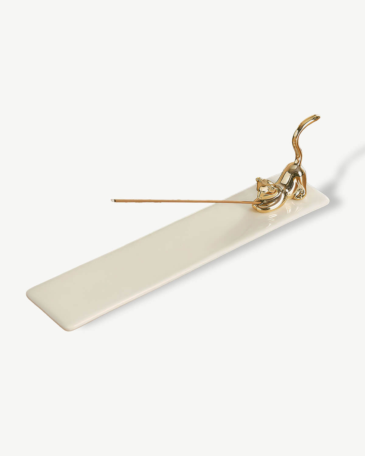 a white rectangular object with a gold handle